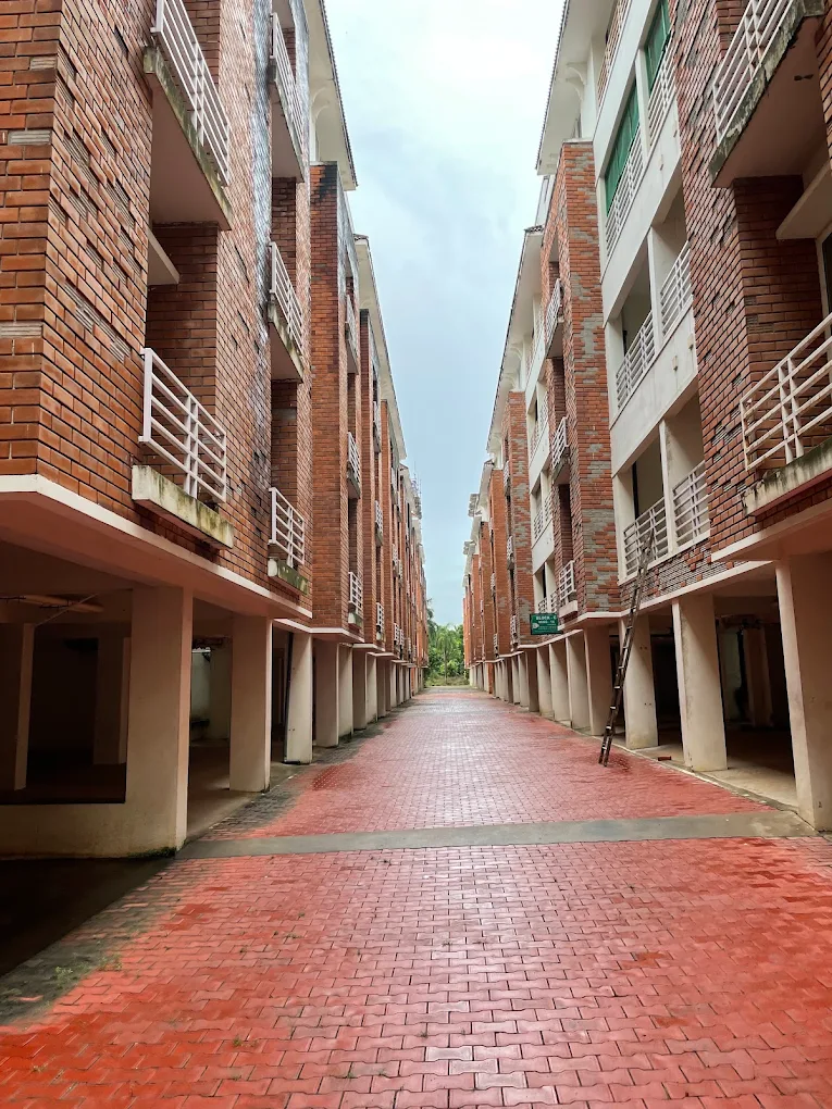 Red brick walkway between apartment towers